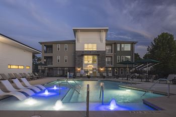 A large house with a pool in front of it.